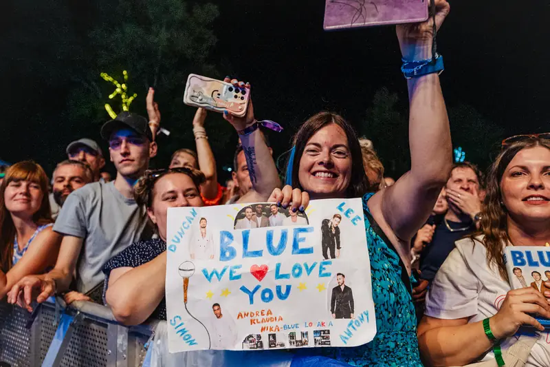 Fans with a banner for the band Blue