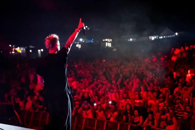Artist and crowd in red light