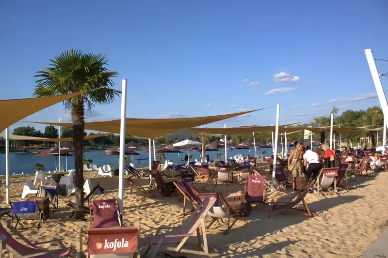 Beach bar with loungers by the water